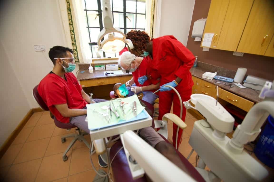 Child getting teeth cleaned in clinic